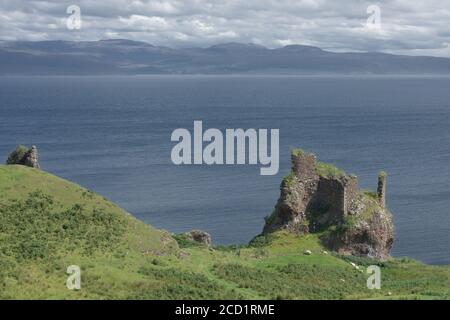 Old ruined coastal castle, brochel castle, on the shores of the inner sound and isle of Raasay in scotland. Sunny day with a cloudy sky. Stock Photo