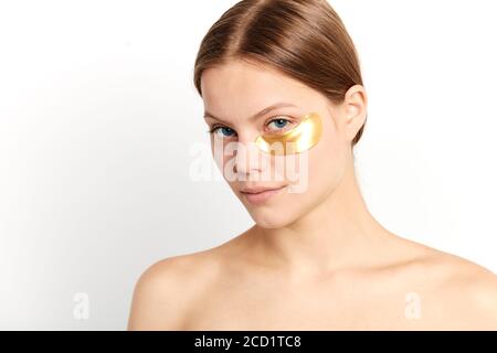 young lovely girl wants to have smooth and soft facial skin, close up portrait, isolated white background, studio shot. Stock Photo