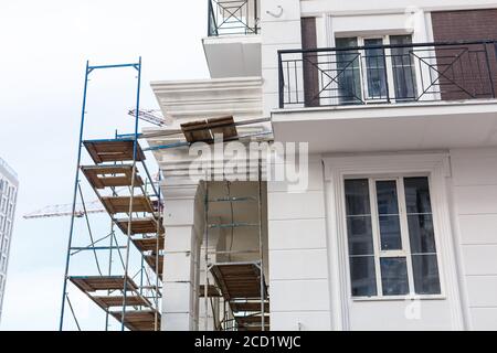 Extensive scaffolding providing platforms for work in progress on a new apartment block UK Stock Photo
