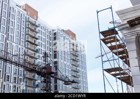 Extensive scaffolding providing platforms for work in progress on a new apartment block UK Stock Photo