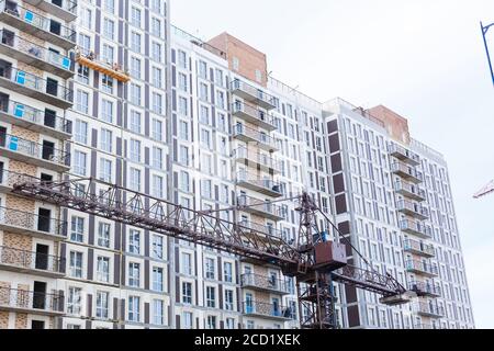 Extensive scaffolding providing platforms for work in progress on a new apartment block UK Stock Photo