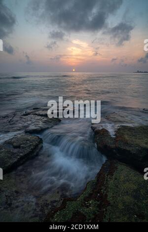 A long exposure of water over rocks. Taken at Point of Rocks in Sarasota, FL. Stock Photo