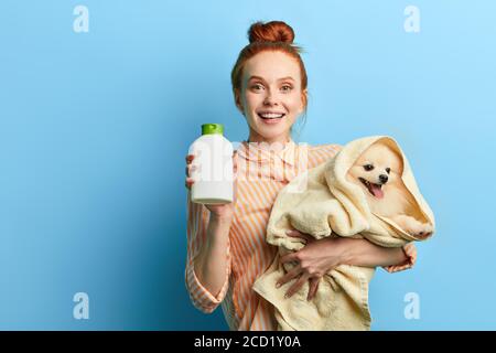 good looking smiling holding her favourite pet and showing soap to the camera,wellness, wellbeing, close up portrait, studio shot.happiness Stock Photo