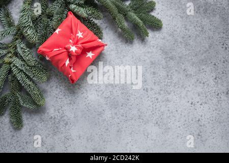 Christmas gifts wrapped in red textile. Zero waste. Xmas. Furoshiki style. Stock Photo