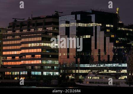 Night view of buildings along Lower Thames Street on north side of river - St Magnus House (left) and Northern & Shell Building (right), London, UK Stock Photo