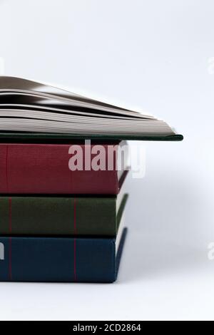 A stack of books lying on a white background, learning, education, study Stock Photo