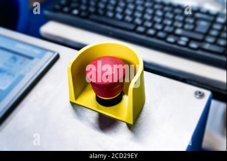 Red emergency button on black panel. Stop Stock Photo