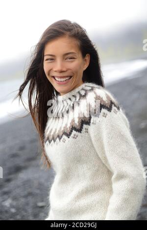 Winter sweater Asian woman wearing icelandic pattern wool knitted handmade sweater on Iceland travel, Chinese tourist with traditional wear for the Stock Photo