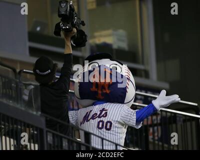 Queens, United States. 25th Aug, 2020. New York Mets mascot Mr. Met wears a face mask when he performs for a TV camera in the game against the Miami Marlins at Citi Field on Tuesday, August 25, 2020 in New York City. Mets general manager Brodie Van Wagenen said the team's coronavirus cases appeared to be limited to the player and coach who tested positive Thursday and MLB announced the Mets would resume play Tuesday with a doubleheader against the Marlins. Photo by John Angelillo/UPI Credit: UPI/Alamy Live News Stock Photo