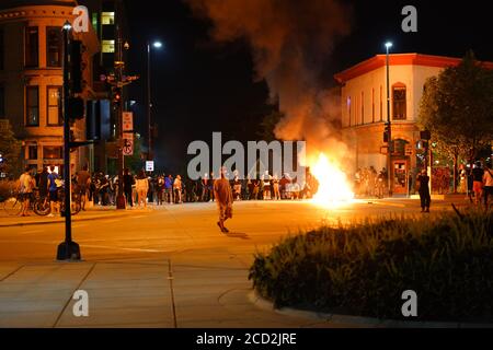 Rioters in the streets of wisconsin state capitol madison light fires in garbage bins to protest the death of jacob black of kenosha. Stock Photo