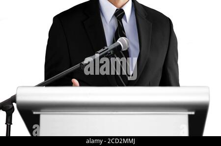 man giving speech using microphone on stage Stock Photo