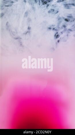Colorful abstract art Acrylic painting background texture in water creates an interesting abstraction on a black background. Spray of pink colors. Stock Photo