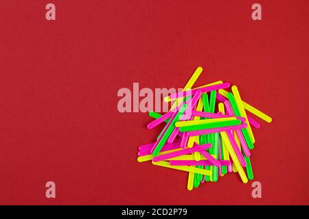 Counting sticks of different colors for classes with children on red paper background with copy space. school stationery. Preparing for school with co Stock Photo