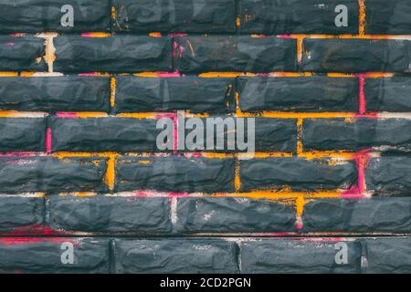 Black brick wall background, grunge texture, painted stone wall, abstract architecture pattern. Urban street, art wallpaper. Building's facade Stock Photo