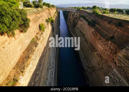 The Corinth Canal connects the Gulf of Corinth in the Ionian Sea with the Saronic Gulf in the Aegean Sea. It cuts through the narrow Isthmus of Corint