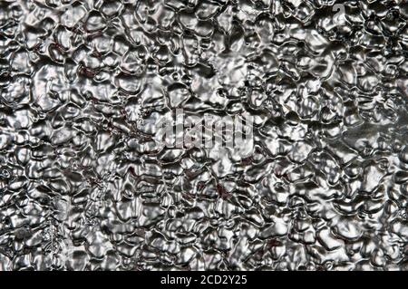 A Close Up Of A Brick Wall Painted In Metallic Silver Paint Stock Photo