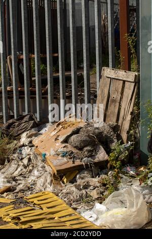 Rubbish unlawfully dumped in an urban alleyway displaying lack of concern for the environment and social irresponsibility. London, England, Europe Stock Photo