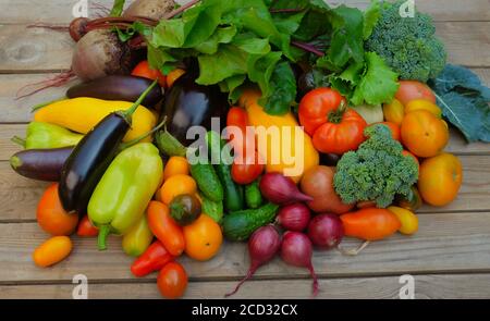 Many different colorful vegetables on a wooden background. Harvest and summer season concept. Stock Photo