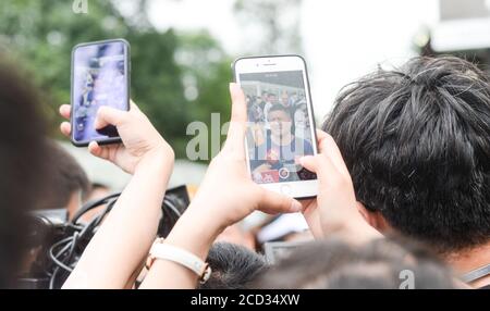 53-year-old Chinese man Liang Shi steps out of the testing center, where he just finished his 24nd Gaokao, also known as the 2020 National College Ent Stock Photo