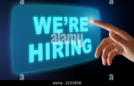 Male hand pressing WE'RE HIRING button on virtual screen over black background, creative collage Stock Photo