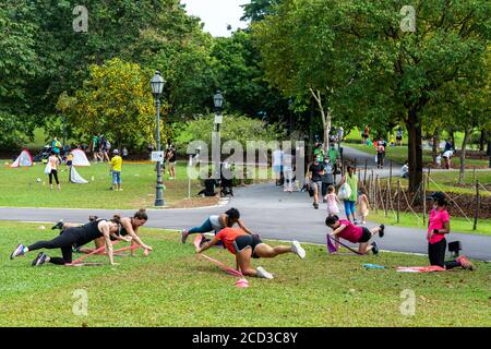 SINGAPORE, SINGAPORE - Aug 15, 2020: Singapore / August 15,2020 : group of people exercising at the Botanic Gardens. Weekend activities. Stock Photo