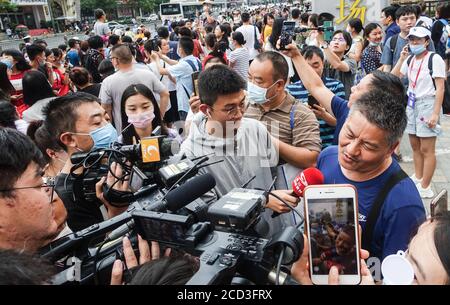 53-year-old Chinese man Liang Shi steps out of the testing center, where he just finished his 24nd Gaokao, also known as the 2020 National College Ent Stock Photo