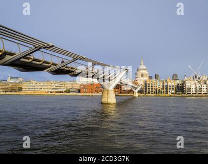 View from the south bank of the River Thames over Millennium Bridge to the north bank of the Embankment and St Paul's Cathedral, City of London Stock Photo