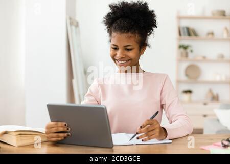 Secondary School Student Girl Studying Using Digital Tablet At Home Stock Photo