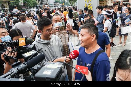 53-year-old Chinese man Liang Shi steps out of the testing center, where he just finished his 24nd Gaokao, also known as the 2020 National College Ent Stock Photo