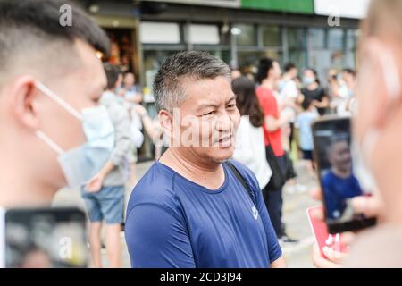 53-year-old Chinese man Liang Shi steps out of the testing center, where he just finished his 24nd Gaokao, also known as the 2020 National College Ent Stock Photo