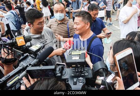 53-year-old Chinese man Liang Shi steps out of the testing center, where he just finished his 24nd Gaokao, also known as the 2020 National College Ent Stock Photo