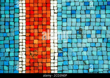 Blue and turquoise and red old antique mosaic tiles on the bottom of the fountain as a background. Stock Photo