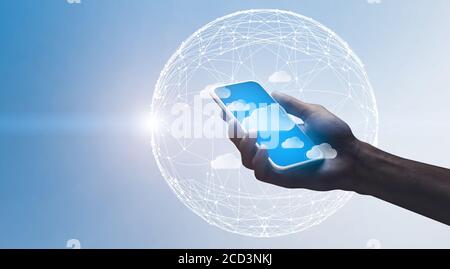 Cloud Computing. Hand holding smartphone with flying data storage cloud icons Stock Photo