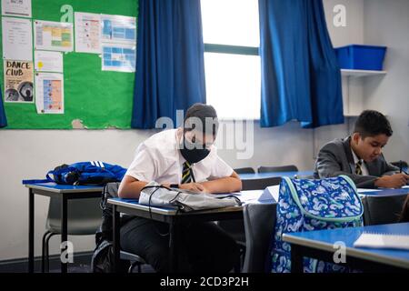 Pupils from years 7 and 11 return to Manor High School in Oadby, Leicestershire, currently the school has adopted a voluntary policy with regards to students wearing face coverings. Stock Photo