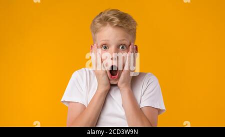 Surprised shocked little boy looking at camera Stock Photo