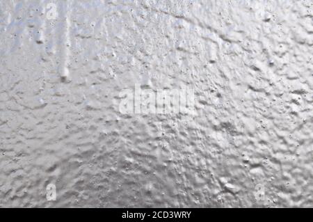 Concrete wall background with applied silver paint. Stock Photo