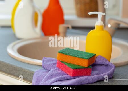 Household chemicals product bottles standing near the kitchen sink Stock Photo