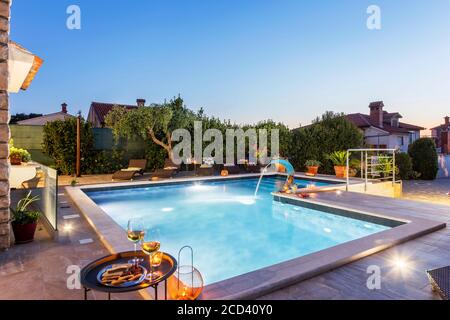 holiday home with swimming pool at dusk Stock Photo