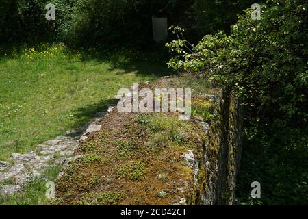 Closeup shot of artfully built walls and green moss with natural stone Stock Photo