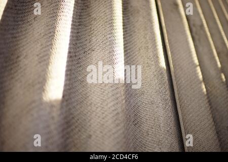 Grey asbestos cement slate fence closeup. Bottom view Stock Photo