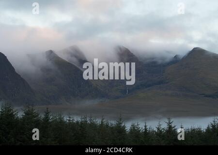 Dramatic clouds and morning mist moving over scenic landscape on the dingle peninsula at dawn, wild Atlantic way in county Kerry, Ireland Stock Photo