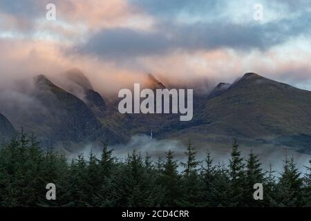 Dramatic clouds and morning mist moving over scenic landscape on the dingle peninsula at dawn, wild Atlantic way in county Kerry, Ireland Stock Photo