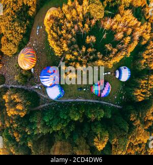 Panoramic air view of hot air ballons prepare for an early morning takeoff from park in small european city, Kiev region, Ukraine Stock Photo