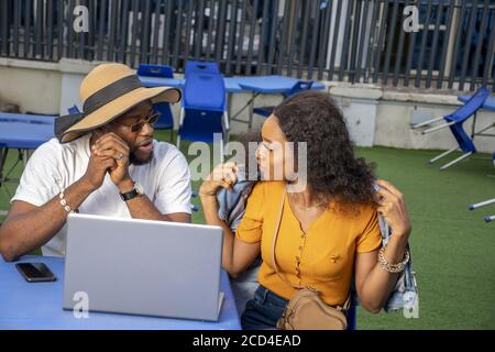 Couple of young African entrepreneurs discussing a possible business venture Stock Photo