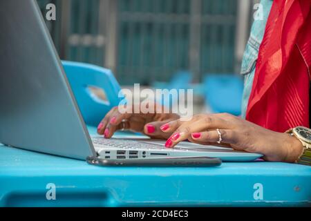 Young African female freelancer working remotely using a laptop Stock Photo