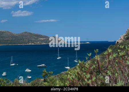 Panoramic view of a beautiful bay with yachts, blue water and old tower. Porto Giunco bay from old Porto Giunco tower. Sardina, Italy Stock Photo