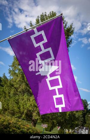 Fonda, New York: Iroquois flag flies outside an Iroquois Museum. The design signifies the confederation of five tribes, led by the Mohawk. Stock Photo