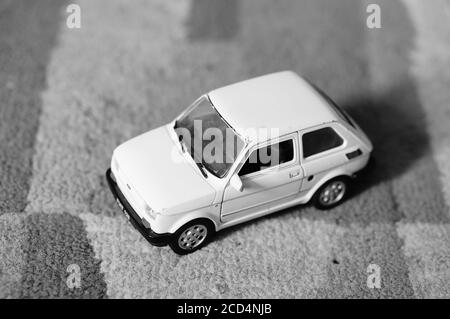 POZN, POLAND - Aug 22, 2020: White Welly Fiat 126 toy model car in soft focus background. Stock Photo