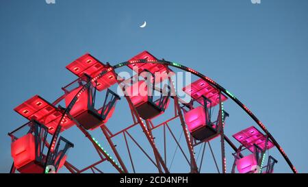 39/5000 Ferris wheel at sunset. With Moon. Stock Photo