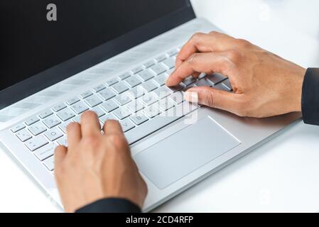 close-up top view of the hands of an afro-american woman using a laptop Stock Photo